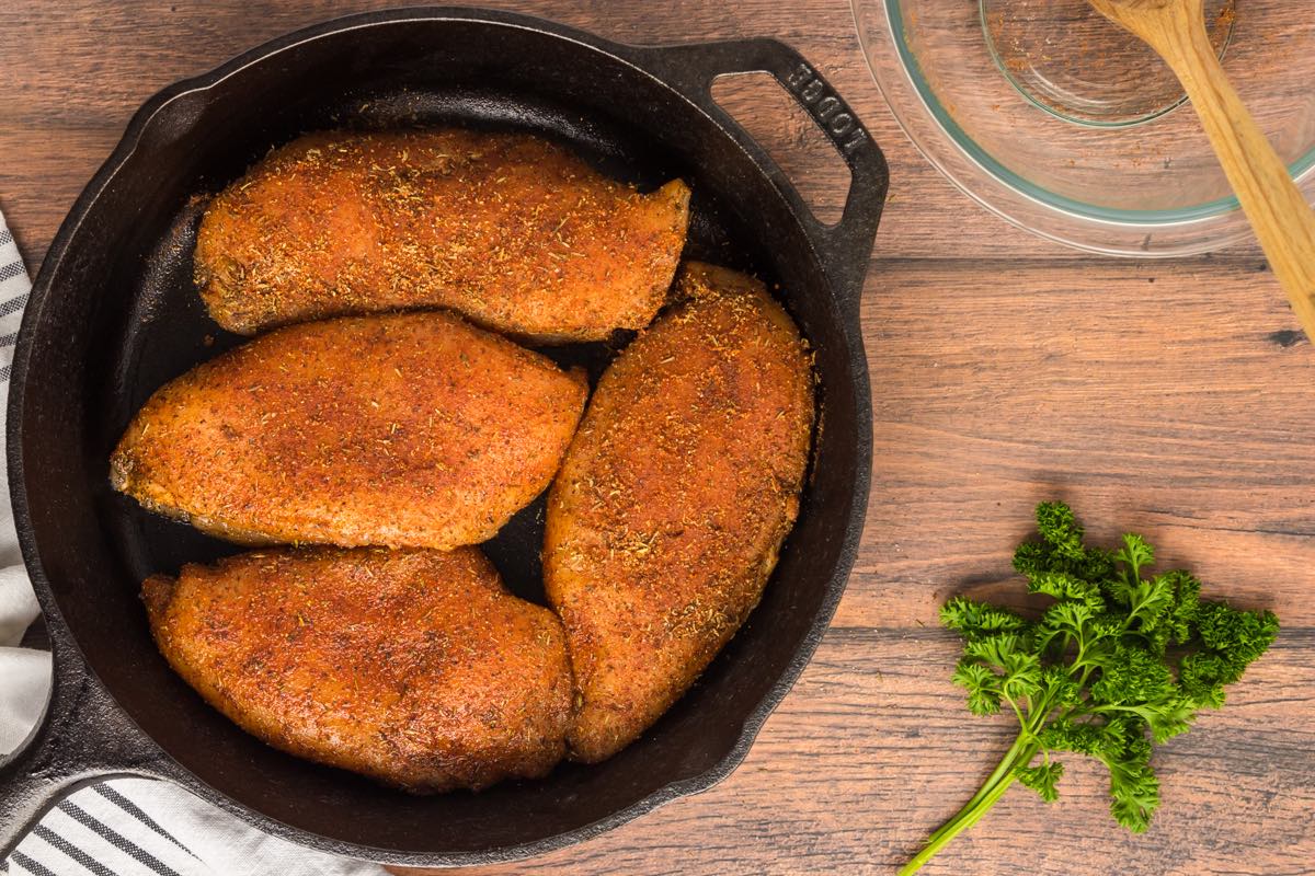 blackened chicken breast in cast iron skillet.