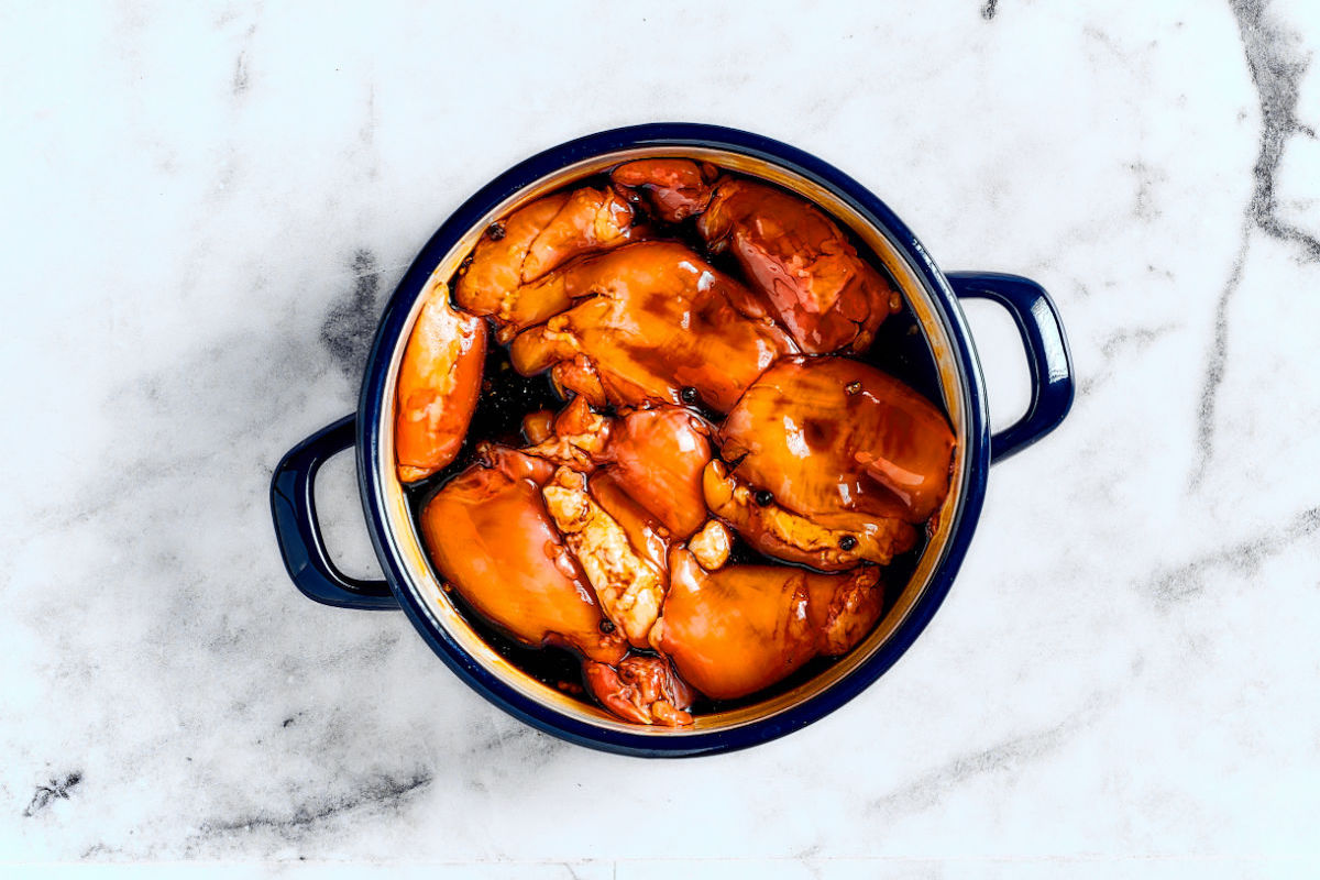 chicken marinating in fillipino adobo sauce.