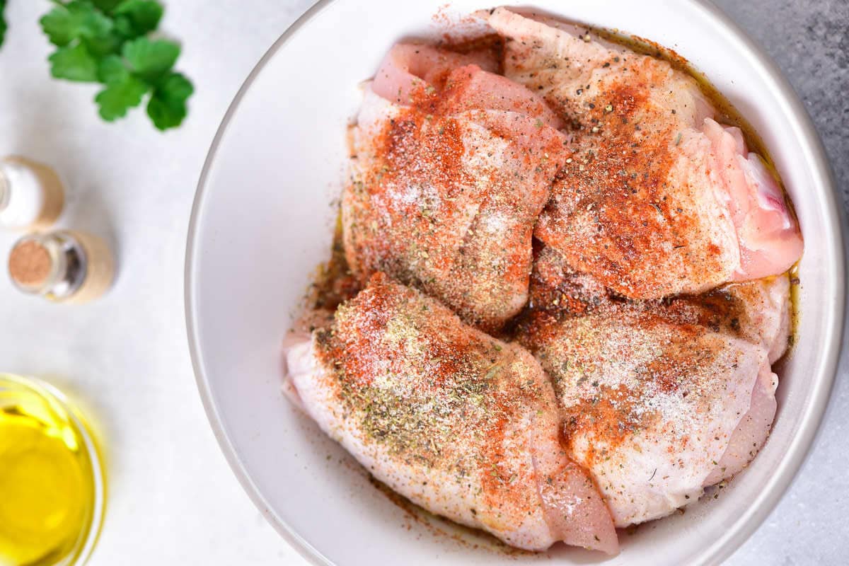 chicken thighs in seasoning.