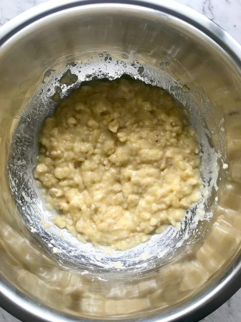 mashed overripe banana in a mixing bowl.