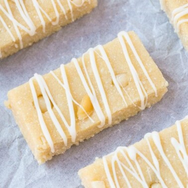 Healthy No Bake White Chocolate Macadamia Nut Protein Bars- Quick, easy and simple no cook recipe which tastes like dessert- Portable, fudgy and ready in under 10 minutes! {vegan, gluten free, paleo recipe}- thebigmansworld.com