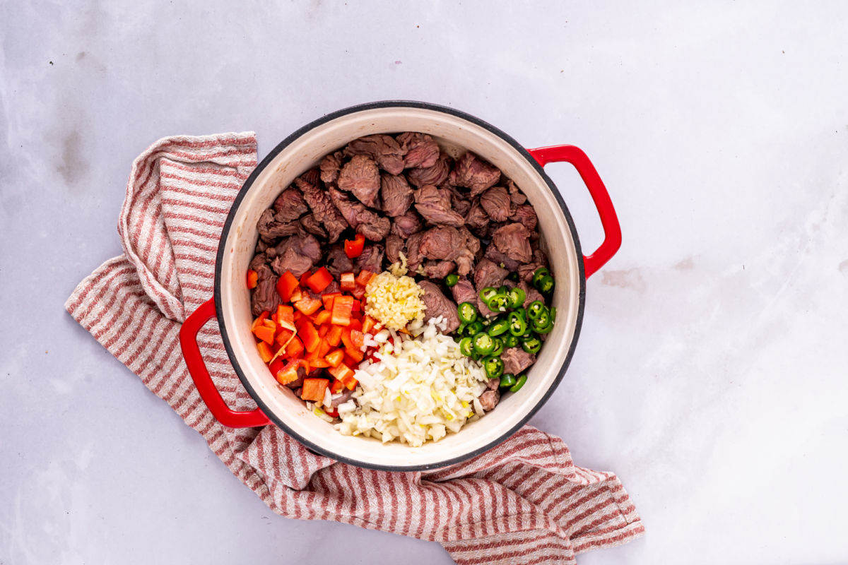 vegetables and beef in Dutch oven.